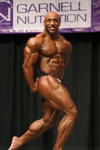 Troy Duracell Brown hits a side Triceps pose