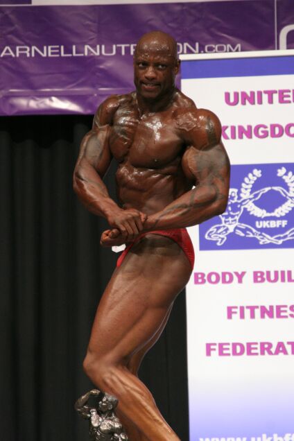 Noah Sidibe hits a side chest pose